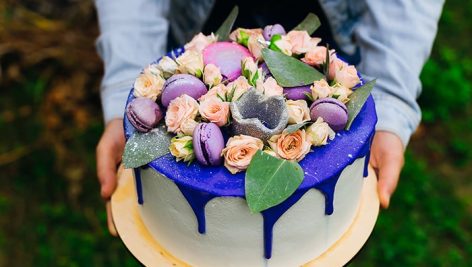 close up girl s hand who holding cake cake with Top